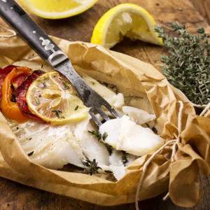 Baked hoki fish with lemon slices and herbs on a wooden surface - New Zealand Hoki Boneless and Skinless Fillets (4 Pieces/Pack, 400g)