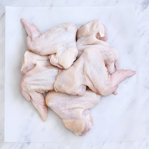Raw chicken wings on a white marble surface - Australian Hormone Free Chicken Whole Wings (400g)