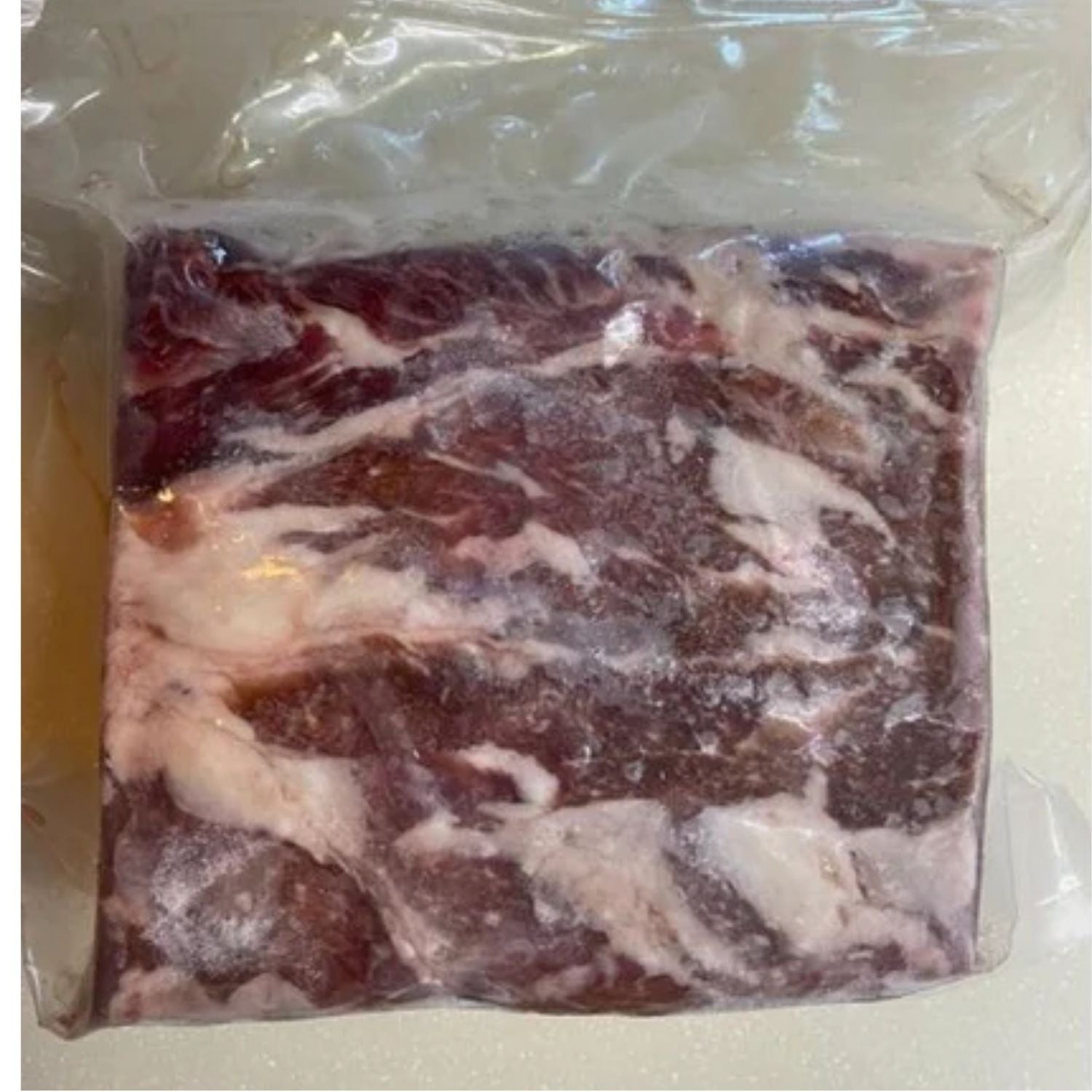 Packaged raw beef ribeye roast in a clear plastic bag on a white background - 澳洲優質黑安格斯肉眼(肋眼,MS 2+,2公斤)