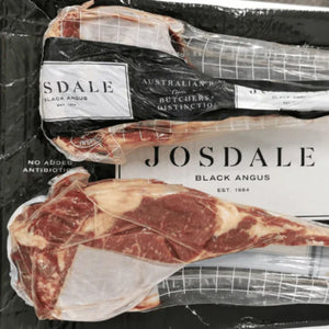 Packaged Josdale Black Angus tomahawk steak with visible branding on a black background - 澳洲優質黑安格斯斧頭扒