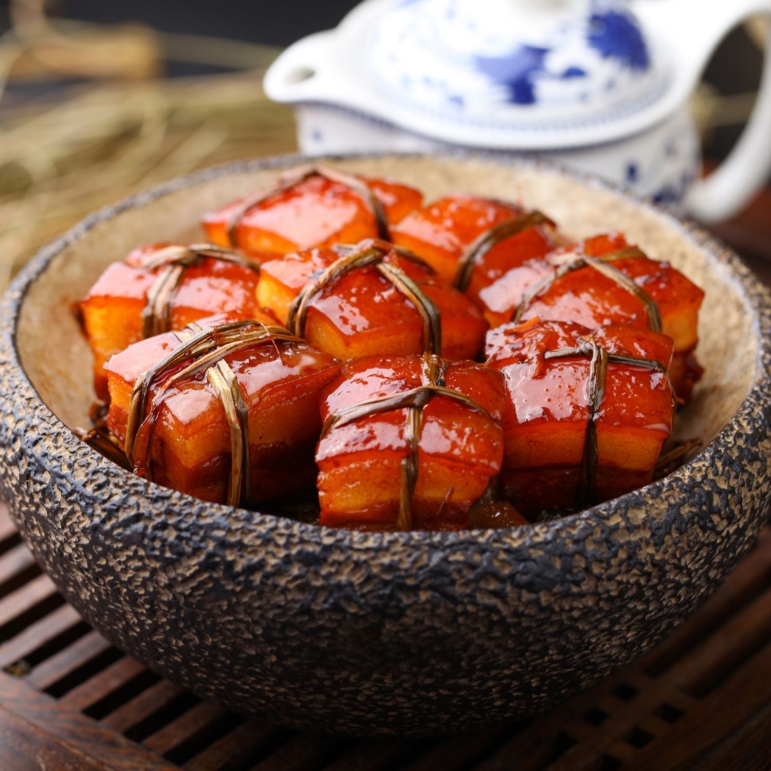 Braised pork belly with a glossy glaze on a textured stone plate. - EU Hormone Free Pork Belly Rind-On (1kg)