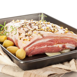 Raw pork belly with garlic cloves and potato on a baking tray - EU Hormone Free Pork Belly Rind-On (1kg)