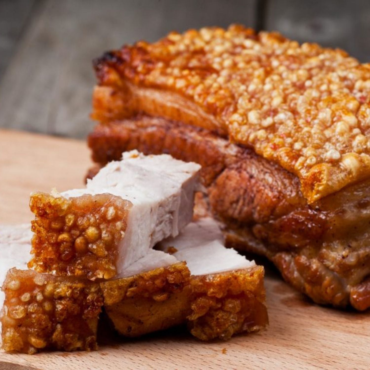 Sliced fried pork belly with crispy skin on a wooden cutting board - EU Hormone Free Pork Belly Rind-On (1kg)