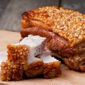 Sliced fried pork belly with crispy skin on a wooden cutting board - EU Hormone Free Pork Belly Rind-On (1kg)