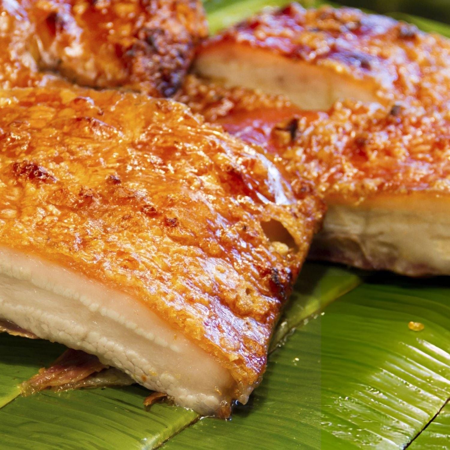 Close-up of sliced friend pork belly on a green banana leaf - EU Hormone Free Pork Belly Rind-On (1kg)