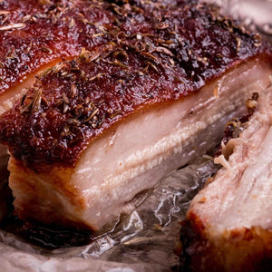Close-up of roasted pork belly with a crispy skin on a piece of tinfoil. - EU Hormone Free Pork Belly Rind-On (1kg)