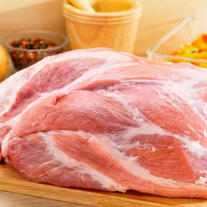 Raw pork shoulder on a wooden cutting board with a blurred background - 歐盟無激素梅花肉(肩膀)(2公斤)|九五折