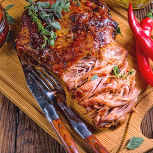 Sliced roasted pork shoulder on a wooden board with herbs and peppers - 歐盟無激素梅花肉(肩膀)(2公斤)|九五折