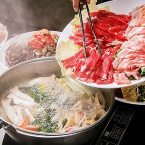 Hot pot with various ingredients being added to a simmering broth - NZ Premium Grass-Fed Lamb Shoulder Hot Pot Slices (300g)