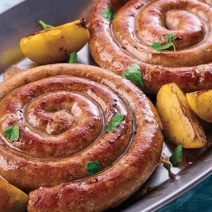 Two large spiral sausages on a plate with lemon wedges and herbs. - Spanish Hormone-Free Duroc Pork Spiral Sausage (250g)