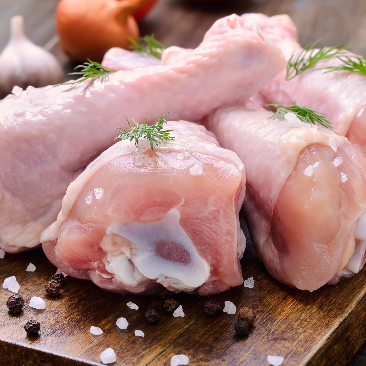 Raw chicken drumettes on a wooden cutting board with herbs and spices - Wholesale Australian Hormone Free Chicken Drumettes (400g) | Buy 20 Get 6 Free