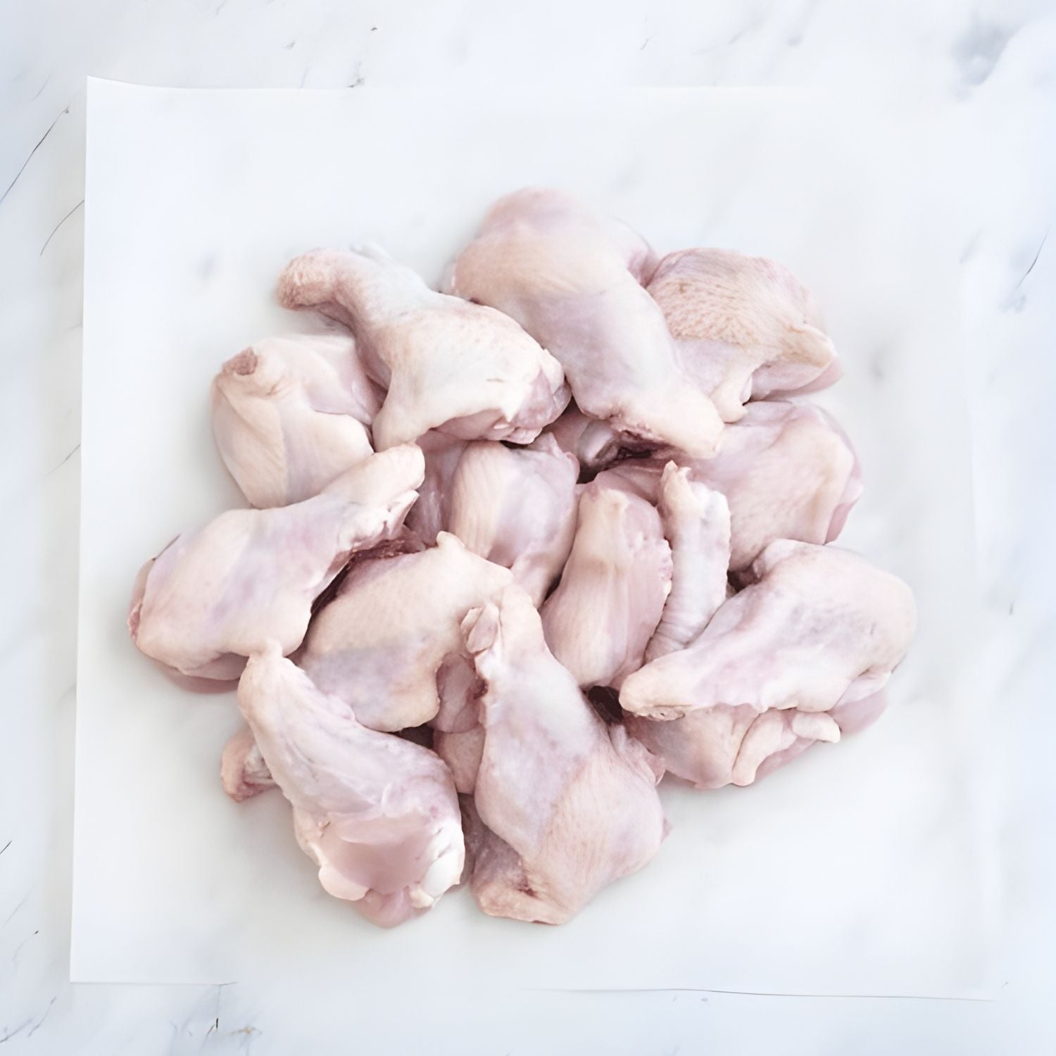 Raw chicken drumettes on a white cutting board - Wholesale Australian Hormone Free Chicken Drumettes (400g) | Buy 20 Get 6 Free