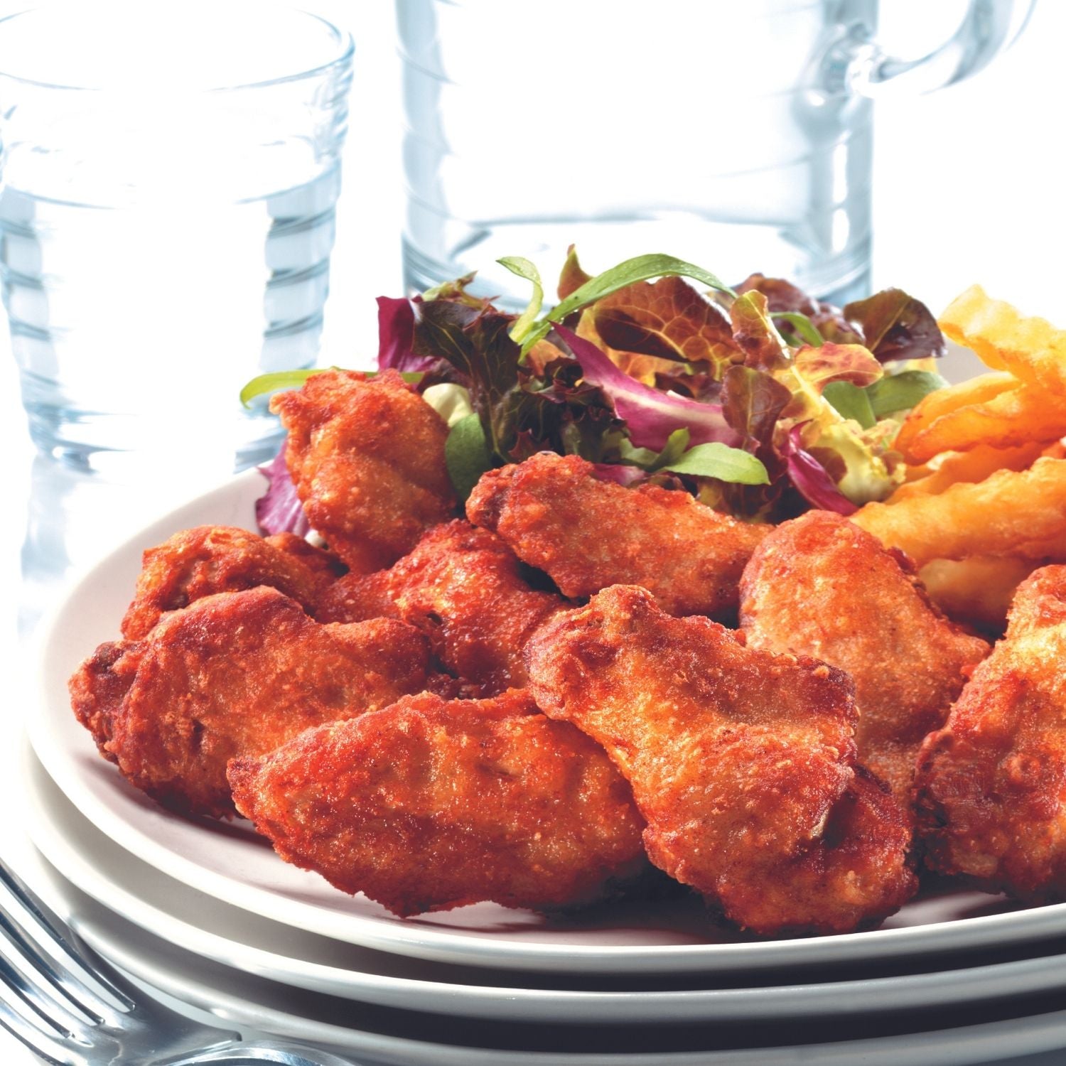 Plated dish of fried chicken drumettes with fries and salad on a white plate. - Wholesale Australian Hormone Free Chicken Drumettes (400g) | Buy 20 Get 6 Free