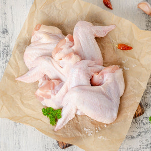 Raw chicken wings on a piece of brown paper with spices on a wooden surface - Wholesale Australian Hormone Free Chicken Whole Wings (400g) | Buy 20 Get 6 Free